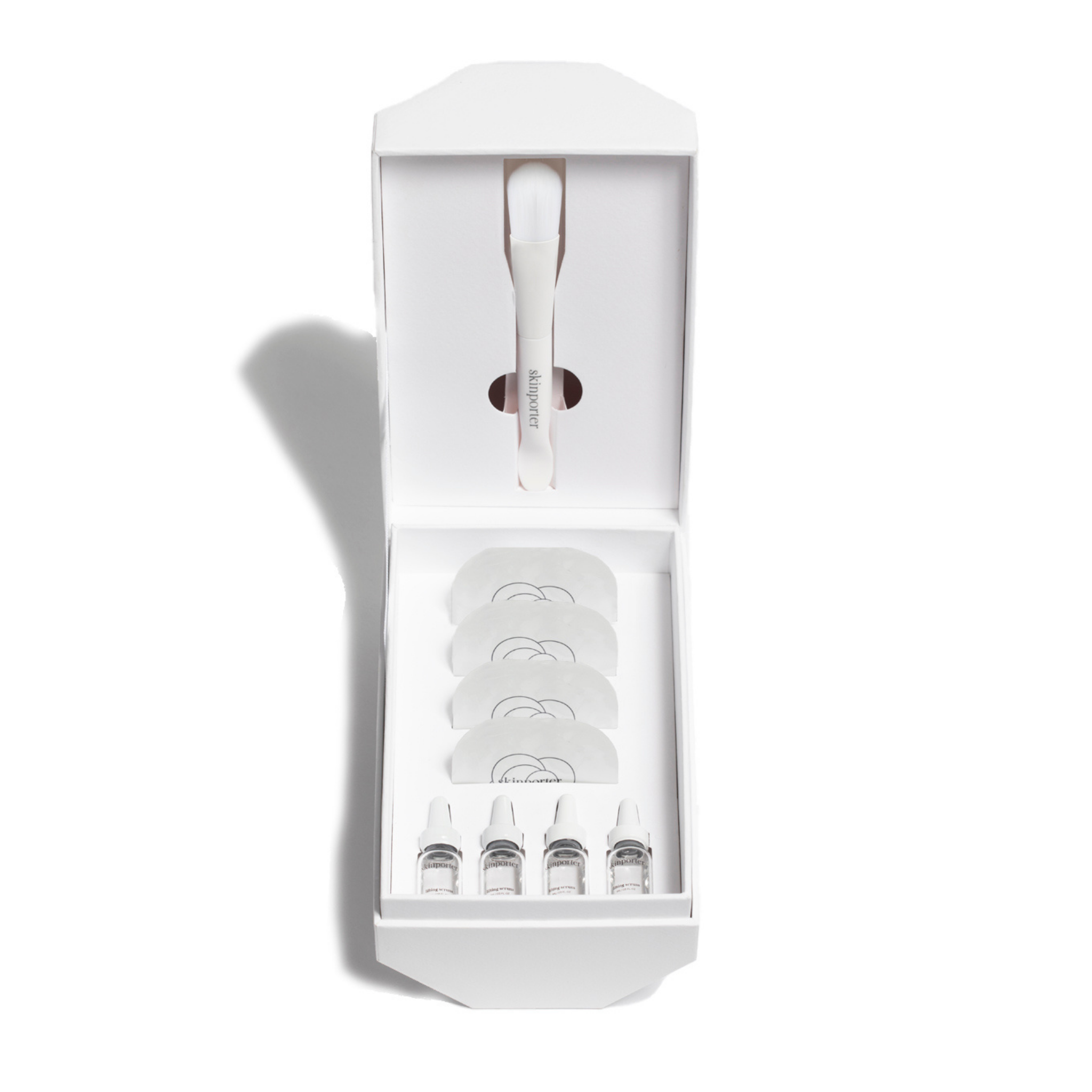 skinporter O₂ Peptide Facial Kit with skincare products and tools arranged neatly for at-home facial treatment